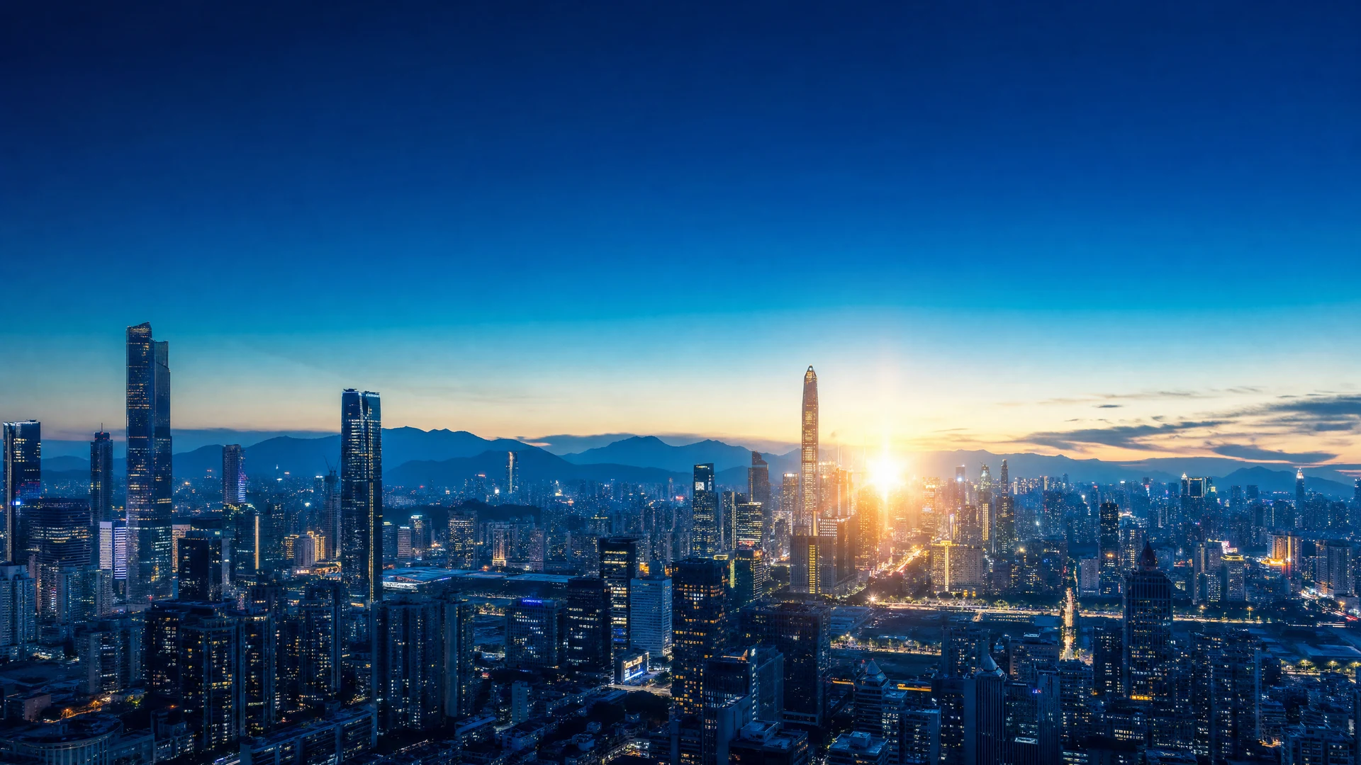 Cinematic dawn cityscape with deep blue gradient sky and glowing skyscraper silhouettes